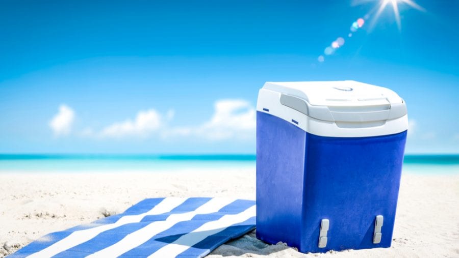 blue cooler on a white sandy beach