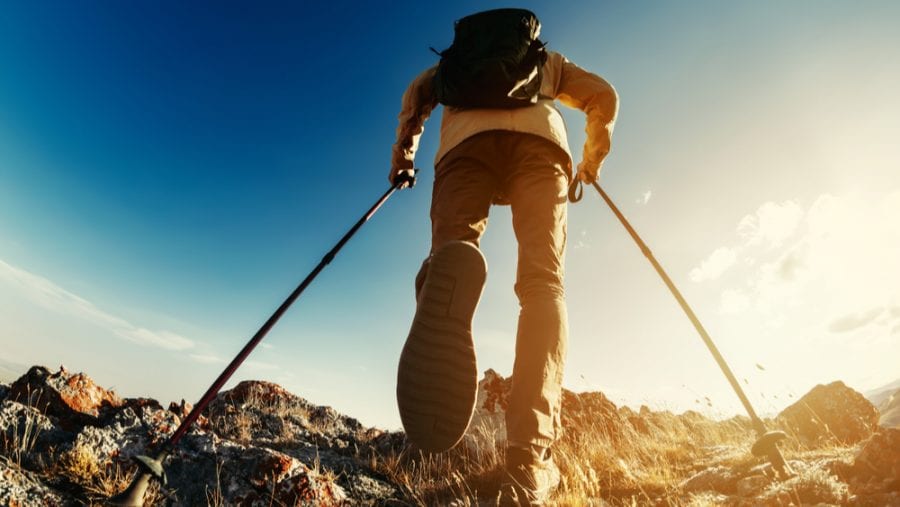hiker with hiking poles uphill