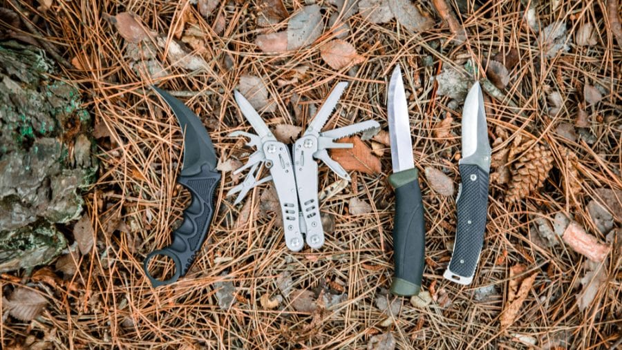 outdoor knives and multitool on the ground