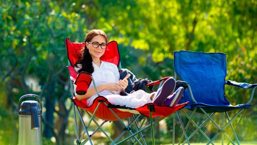 woman sitting on red camping chair