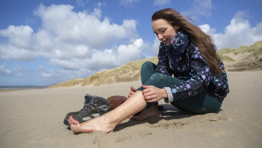 woman taking her hiking boots off for fresh air