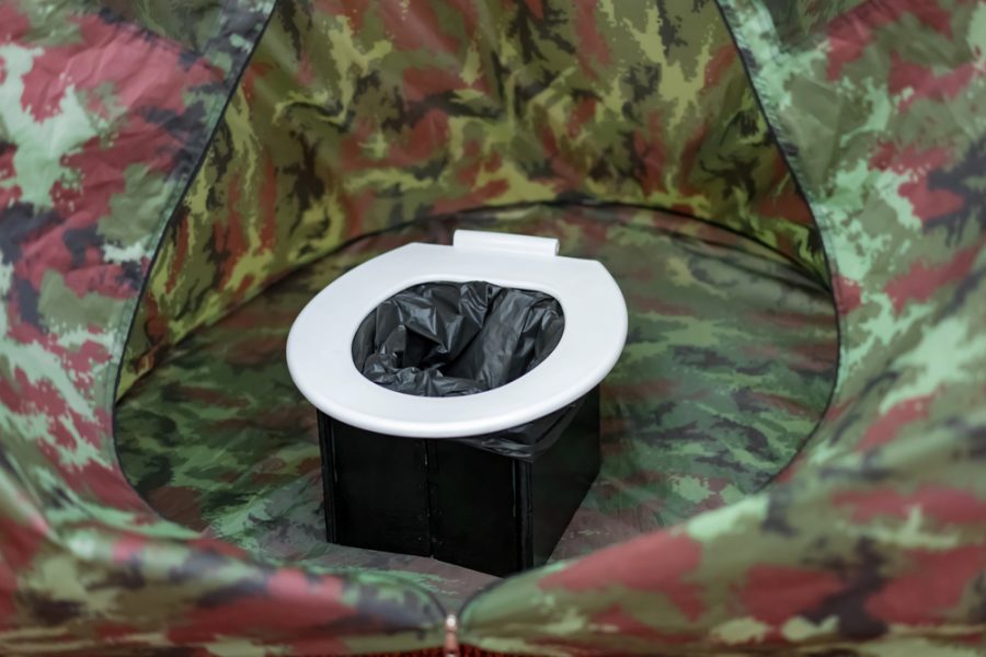 Portable camp toilet inside a tent