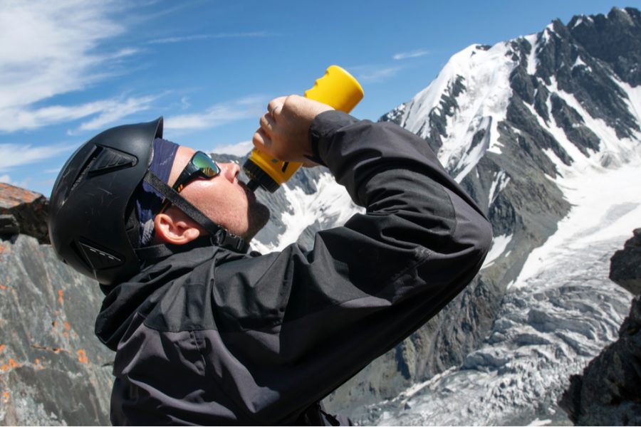 high altitude hiker drinking water