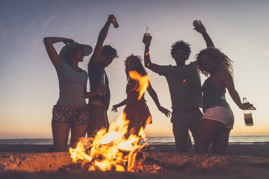 group partying on a small bonfire
