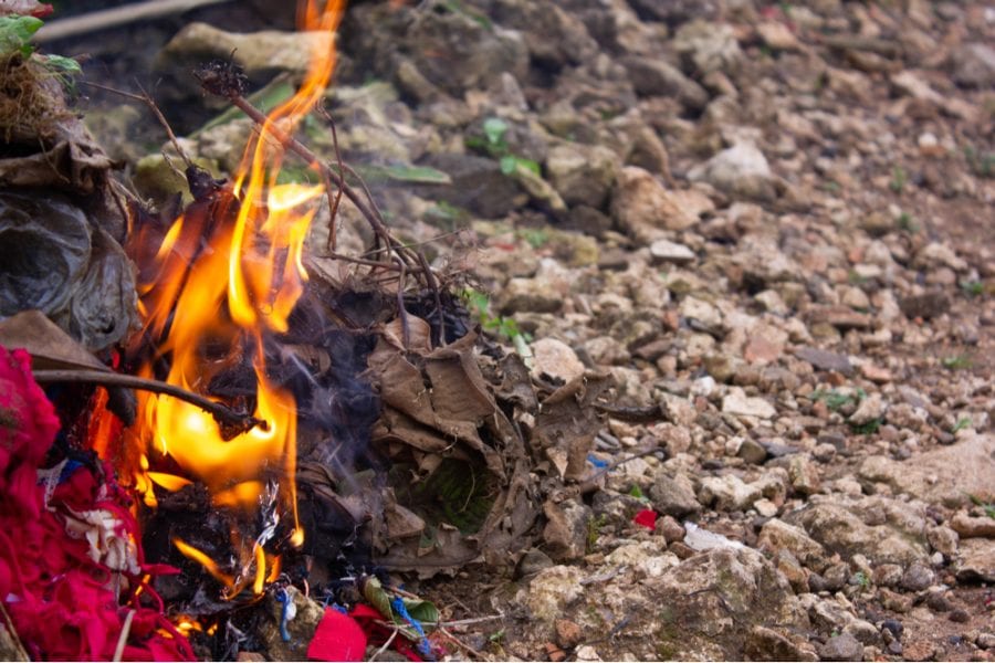 trash burned at a small bonfire